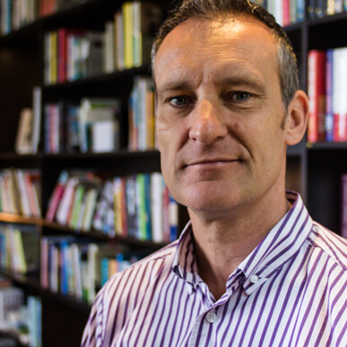 Matt Messias portrait photograph in a library